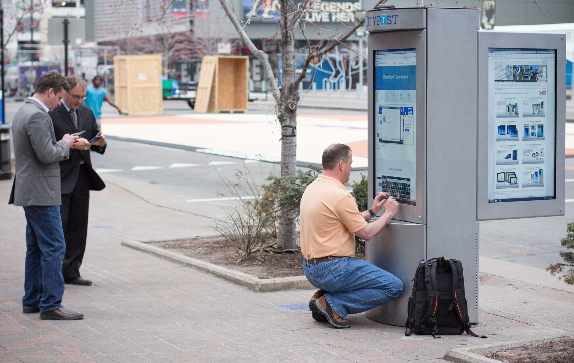 A technician works on the Smart City's digital kiosk.  