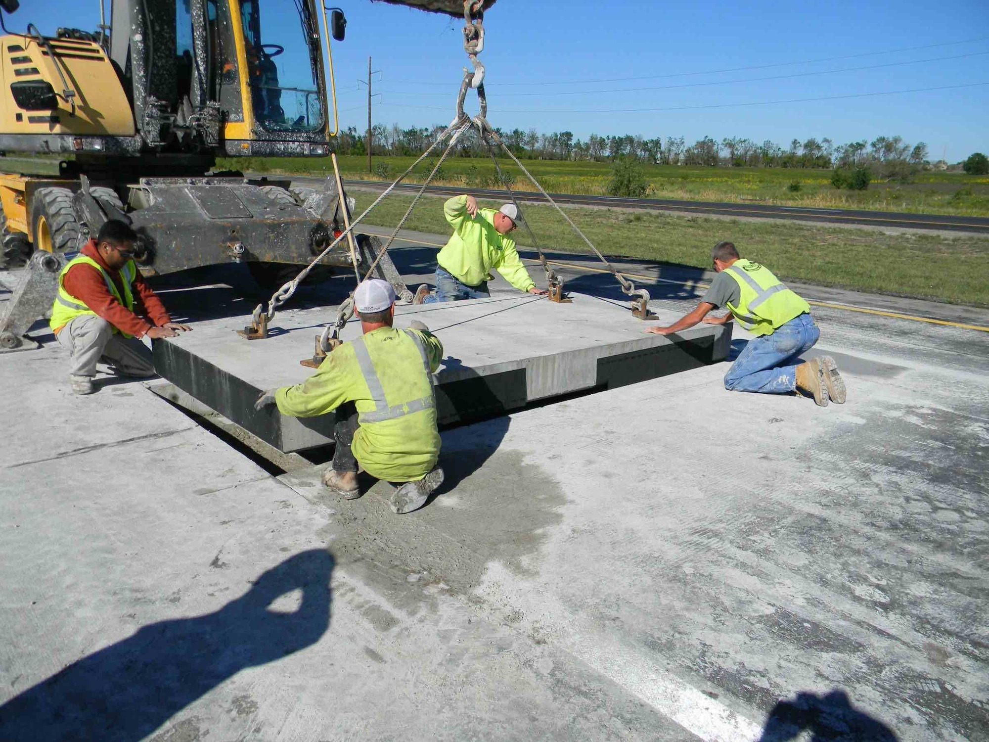 Construction crews install Integrated Roadways' prefabricated, smart pavement system.