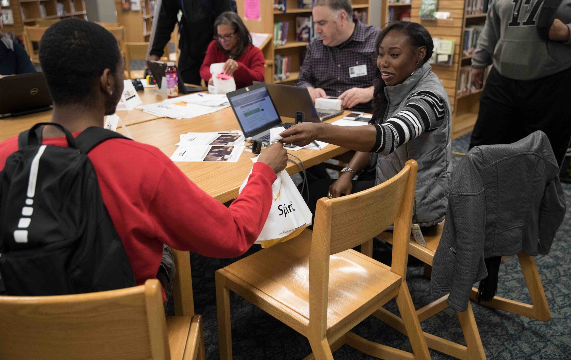 A sprint employee hands an internet hotspot to a Central High School student. 