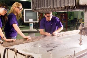 K-State Technology Development Institute student Interns utilizing waterjet cutting system to prototype client parts