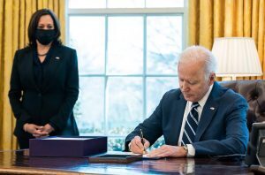 President Biden signs the American Rescue Plan March 11, alongside Vice President Kamala Harris