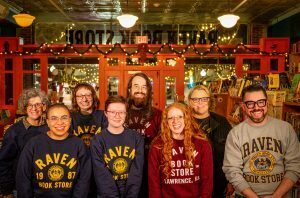 Raven Book Store ownership group, front row: Nikita Imafidon, Mary Wahlmeier Bracciano, Jack Hawthorn, Danny Caine; back row: Kelly Barth, Hannah Reidell, Chris Luxem, Sarah Young.; photo by Adam Smith