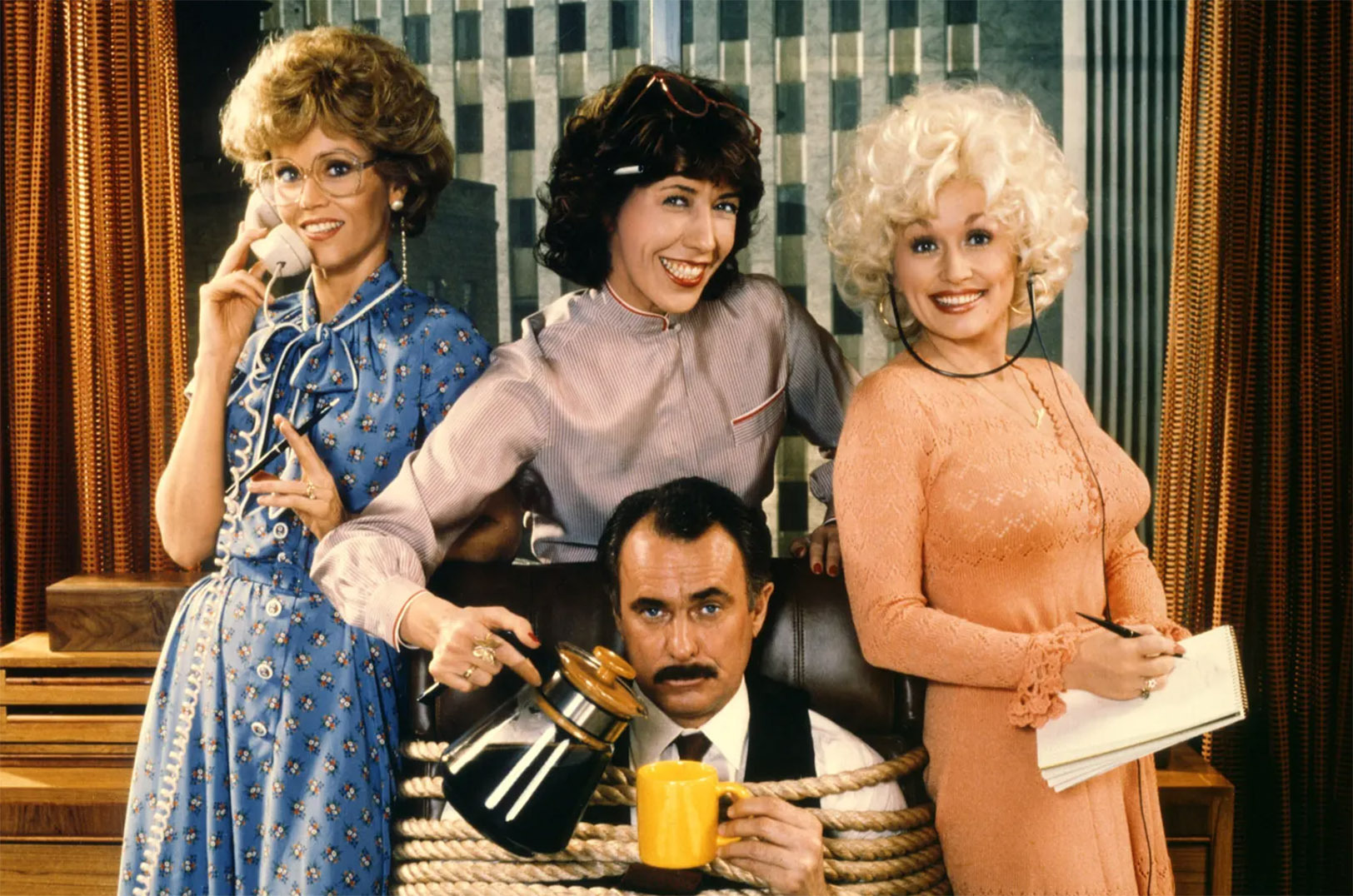 Jane Fonda, Lily Tomlin, Dolly Parton, and Dabney Coleman in a promotional photo for "9 to 5"; photo courtesy of 20th Century Fox