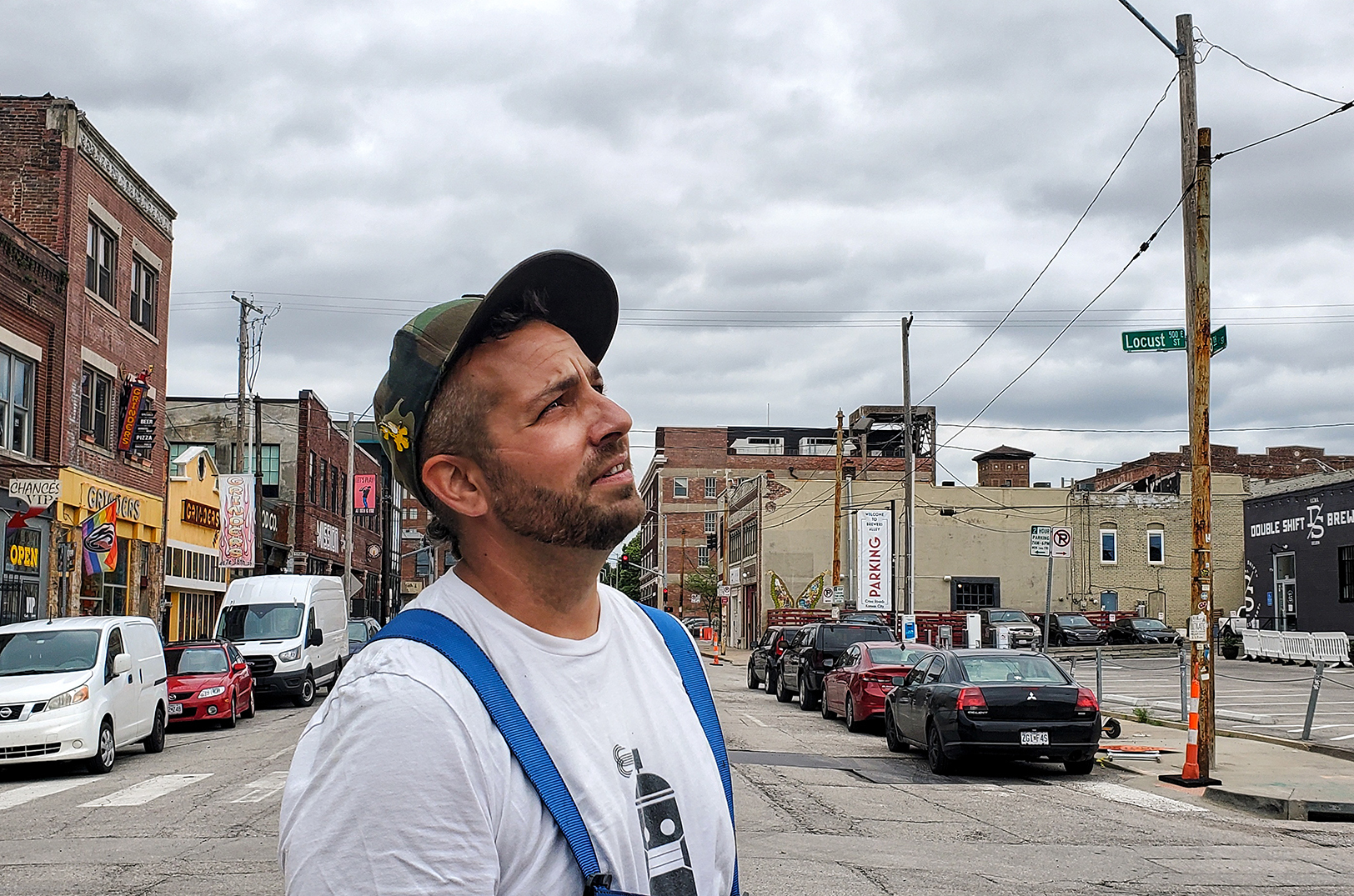 Artist Jason Harrington, also known as Rif Raf Giraffe, looks up at the "King Me" mural at King G in the East Crossroads