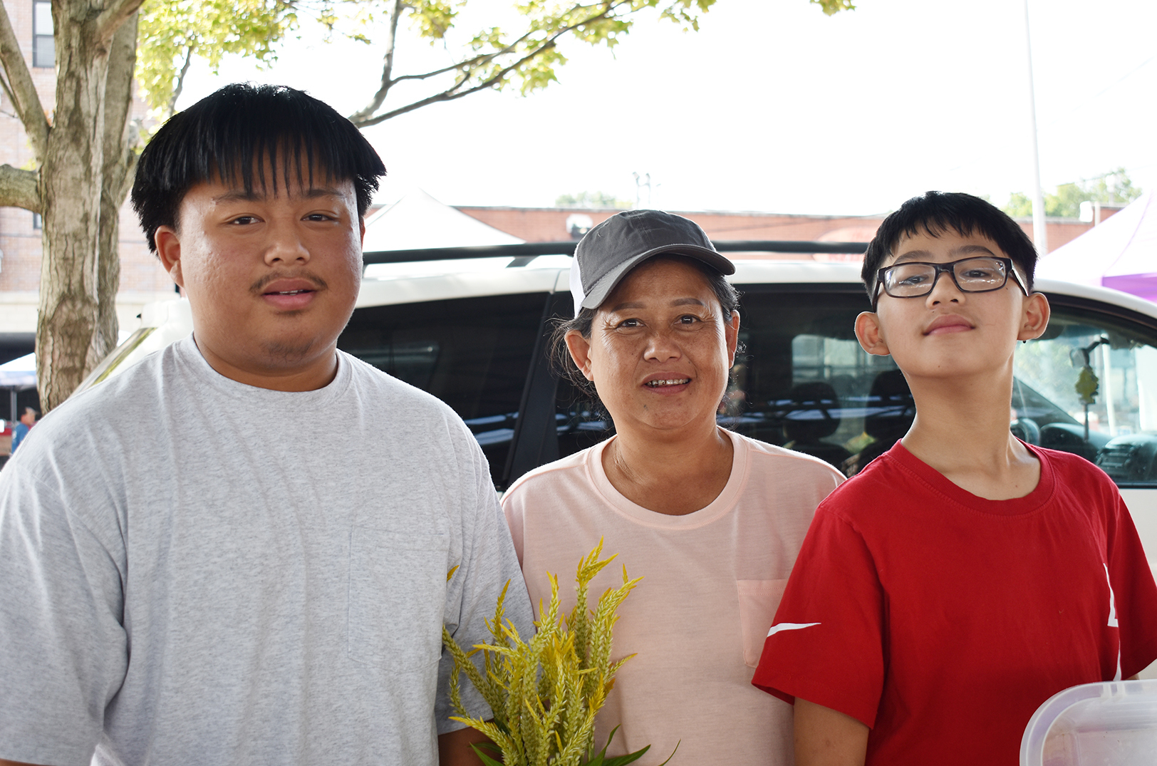 Sur Mu Na, center, and her sons, Pasaw, and Riley na phy, Mo Mo Ru Tha Farm, at the Overland Park Farmers’ Market; photos by Channa Steinmetz, Startland News News