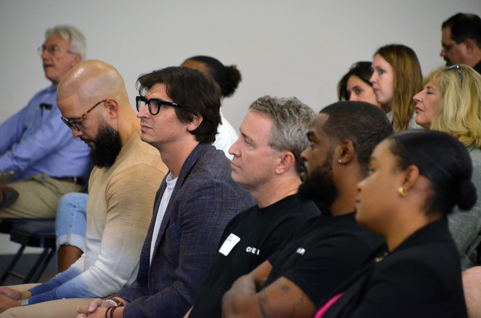Cohort members and mentors listen at the demo day for the LaunchKC Social Venture Studio