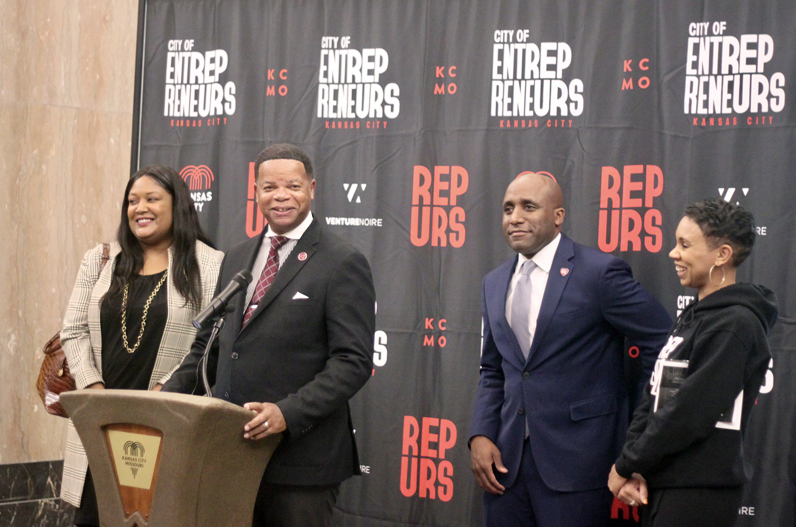 Lance Triggs, Operation HOPE, speaks at the grand opening of KC BizCare's new offices at City Hall