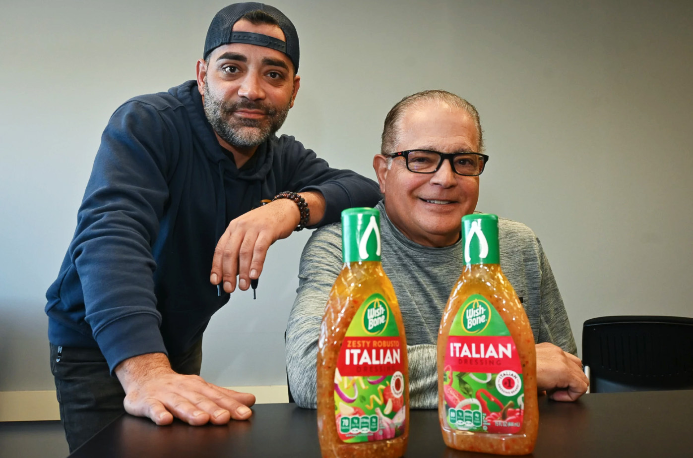 Phillip Sollomi III and Phillip Sollomi Jr. with Wish-Bone Italian salad dressing, created by Phillip Sollomi Sr. in 1948; photo by Carlos Moreno, KCUR 89.3