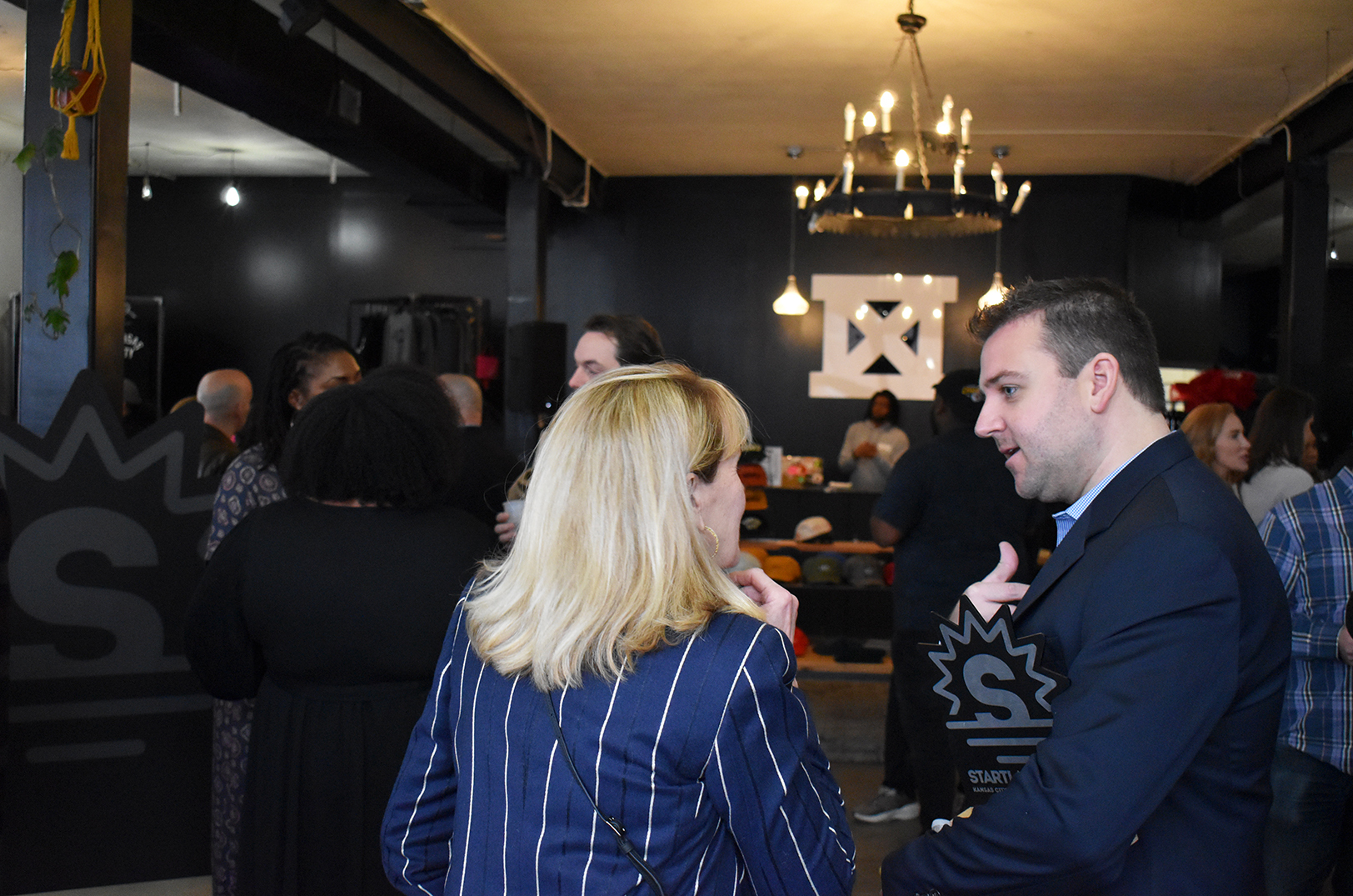 Darcy Howe, KCRise Fund, and Charles Clow, Whipz, talk during Startland News' Kansas City Startups to Watch in 2023 reception at MADE MOBB