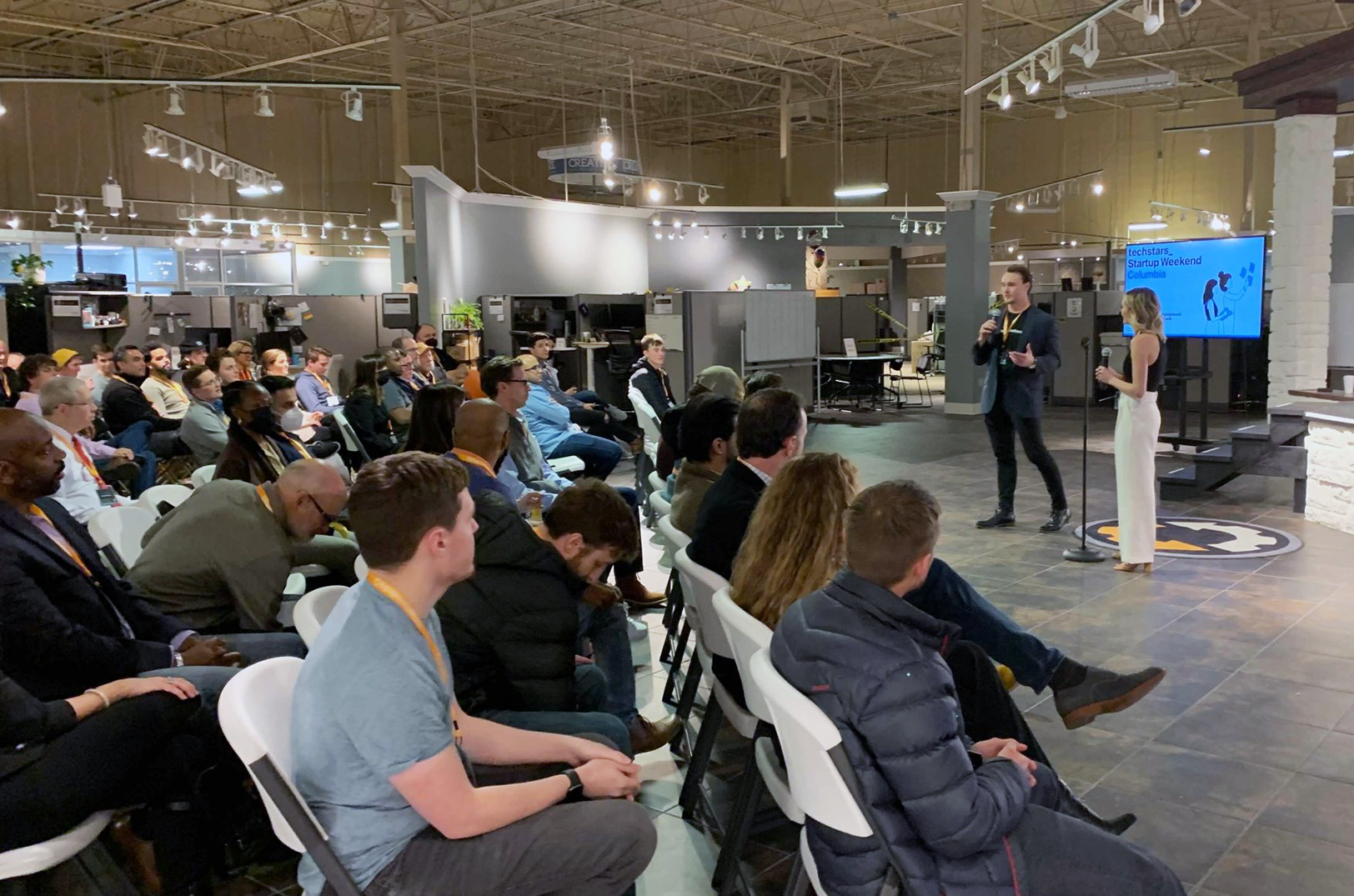 Brett Calhoun and Sas Cairnes, co-chairs of Missouri Startup Weekend, speak at the 2022 Startup Weekend gathering in Columbia, Missouri