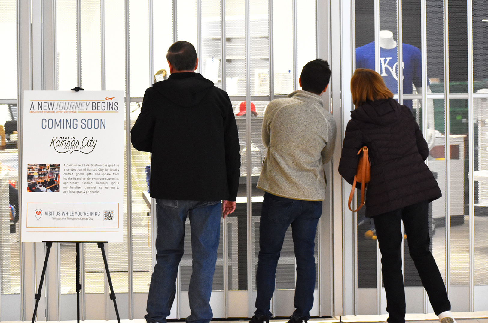 Curious potential shoppers peer into the new Made in KC Marketplace at KCI's new terminal during an open house event