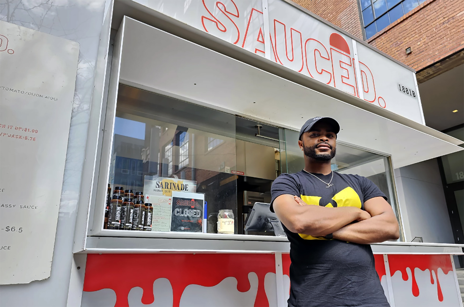 Owner Jayaun Smith stands in front of Sauced. His business will cater to potentially thousands of visitors at the NFL Draft Experience on the National WWI Museum and Memorial lawn; Photo by Chris Fortune, KCUR
