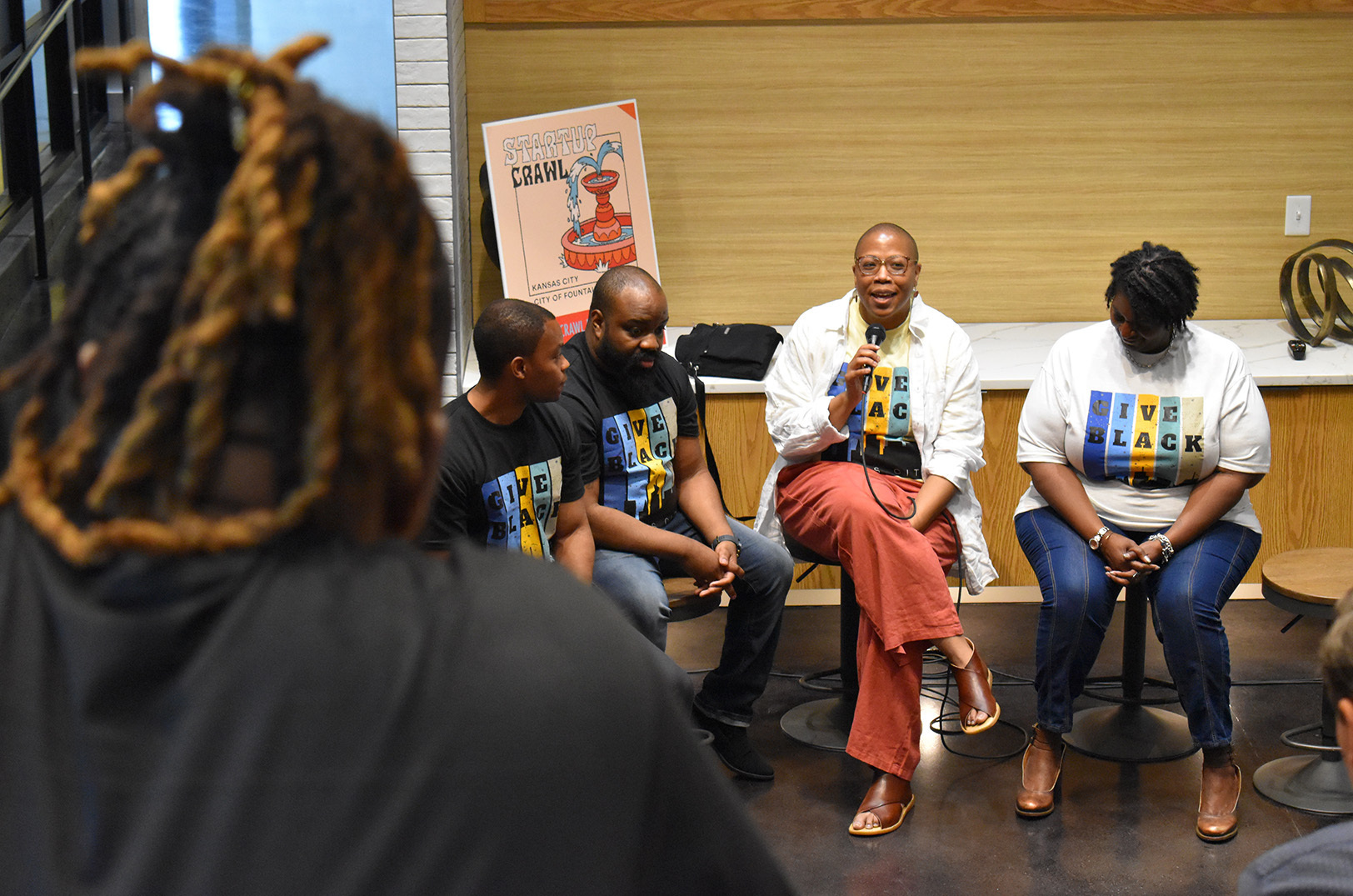 Ja T’aime Taylor, Front Porch Alliance, speaks alongside Give Black KC organizers and fellow recipients during a campaign kickoff event with Startland News at Spark Coworking; photo by Tommy Felts, Startland News