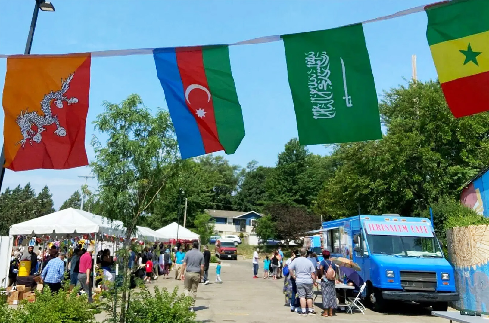 People, businesses and service organizations gathered in the parking lot of the Kansas City Public Library's Northeast Branch for a World Refugee Day event on Saturday. The United Nations has designated June 20 as the official World Refugee Day; Teagan King and Flatland