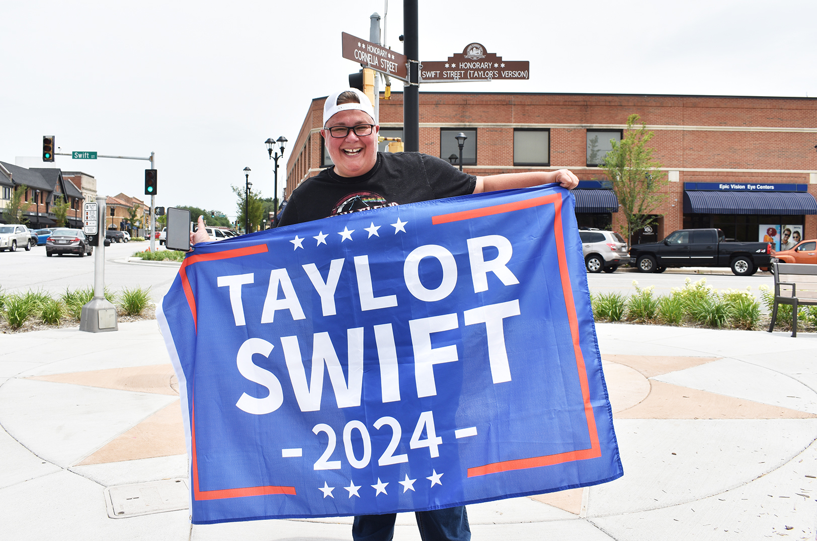 One of many Taylor Swift fans poses for a photo at the Honorary Cornelia Street and Honorary Swift Street (Taylor’s Version) signs; photo by Channa Steinmetz, Startland News