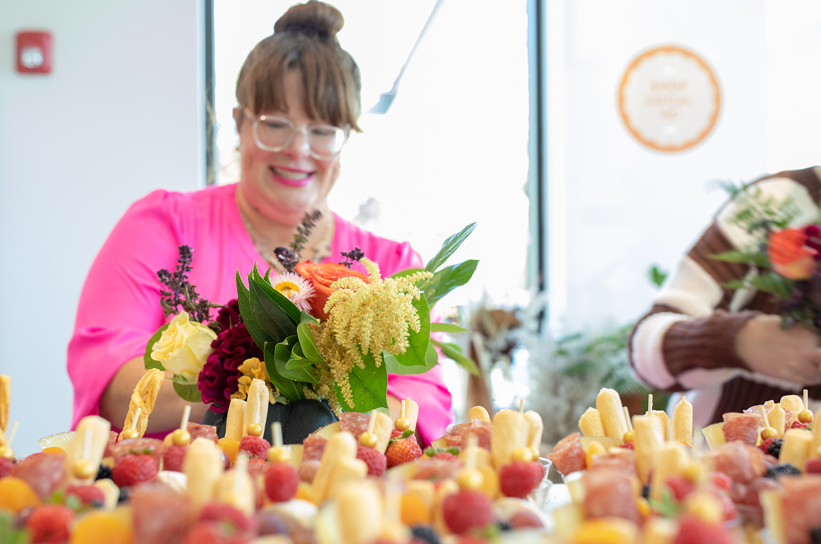 Katie Mabry Van Dieren, Shop Local KC, prepares flowers at the grand opening of the brand's Leawood location in July 2022; photo by nbkc bank