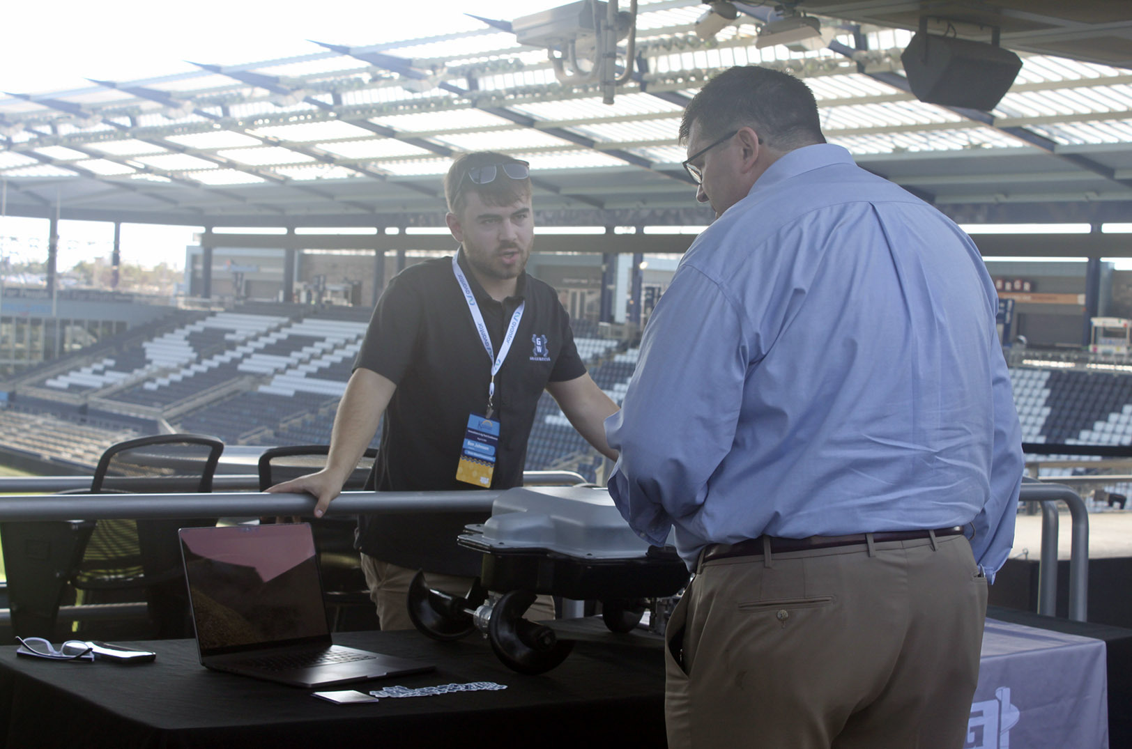 Ben Johnson, co-founder of Aurora, Nebraska-based Grain Weevil — a portfolio company of Grit Road Partners — discusses his startup with an event-goer during the 2022 Innovation Festival at Children's Mercy Park in Kansas City, Kansas; photo courtesy of Grit Road Partners