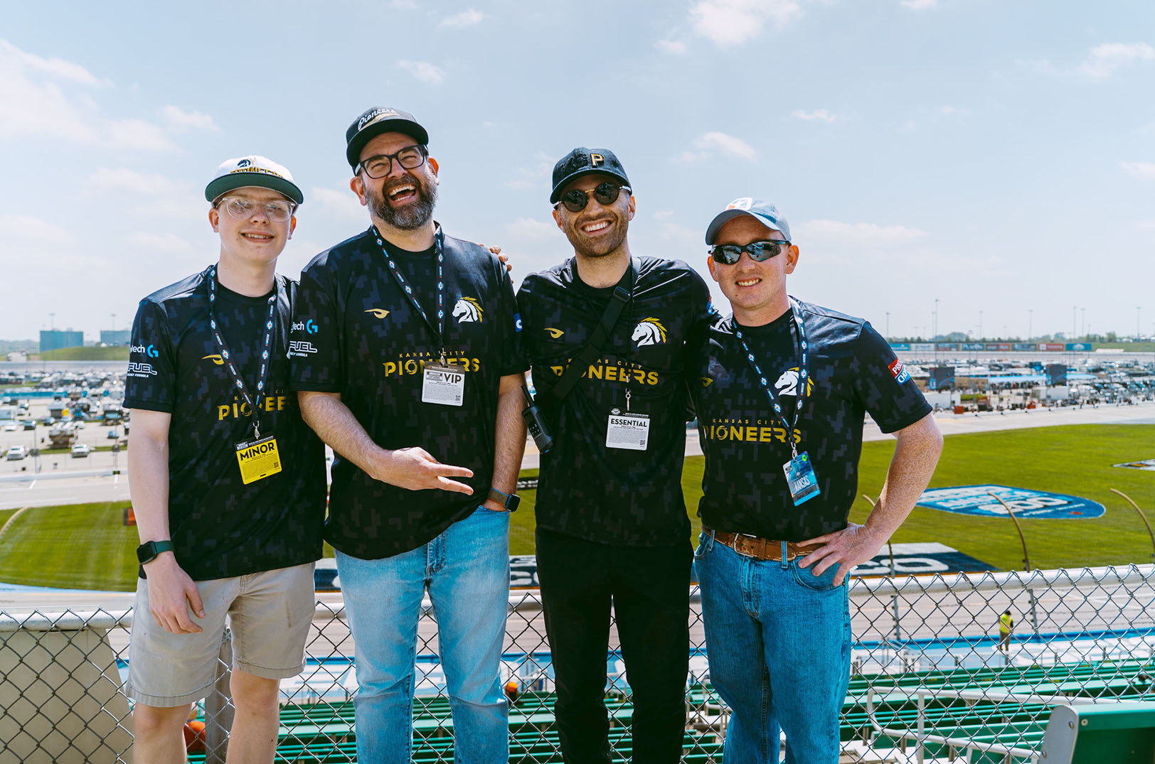 KC Pioneers co-founders Mark Josey and Sam Kulikov, center, with professional eNASCAR drivers Wyatt Tinsley and Derek Justis from the KC Pioneers, at the Kansas Speedway; photo courtesy of the KC Pioneers