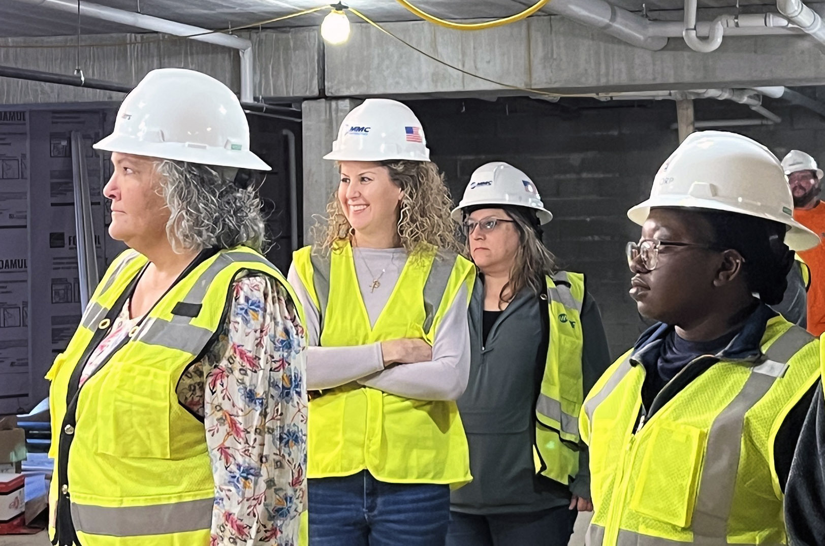 MMC Corp. workers stand at a job site; Photo courtesy of MMC Corp.