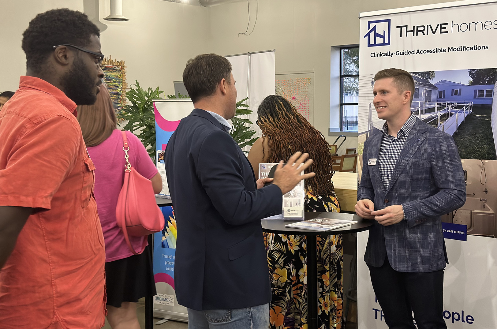 Christian Hill, Thrive Homes, talks with Social Venture Studio demo day attendees; photo courtesy of Social Venture Studio