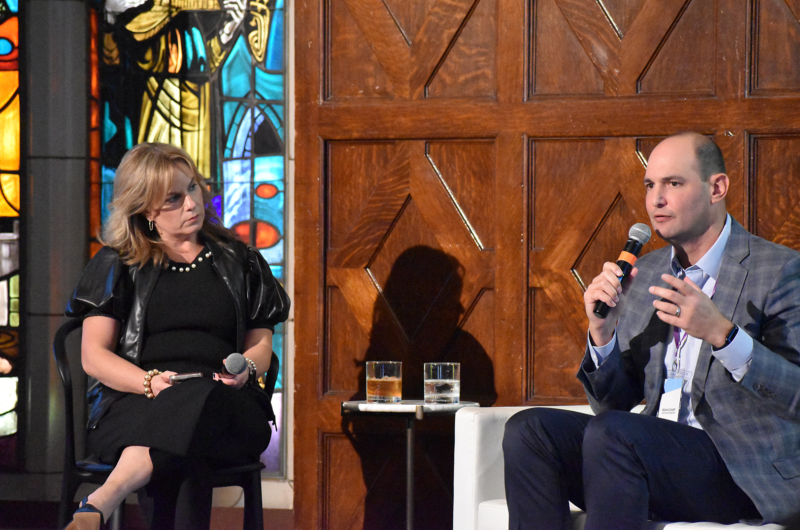 Maggie Kenefake, Iron Prairie Ventures, and Brian Scharf, the Ewing Marion Kauffman Foundation, share a fireside chat on stage at MidxMidwest; photo by Taylor Wilmore, Startland News