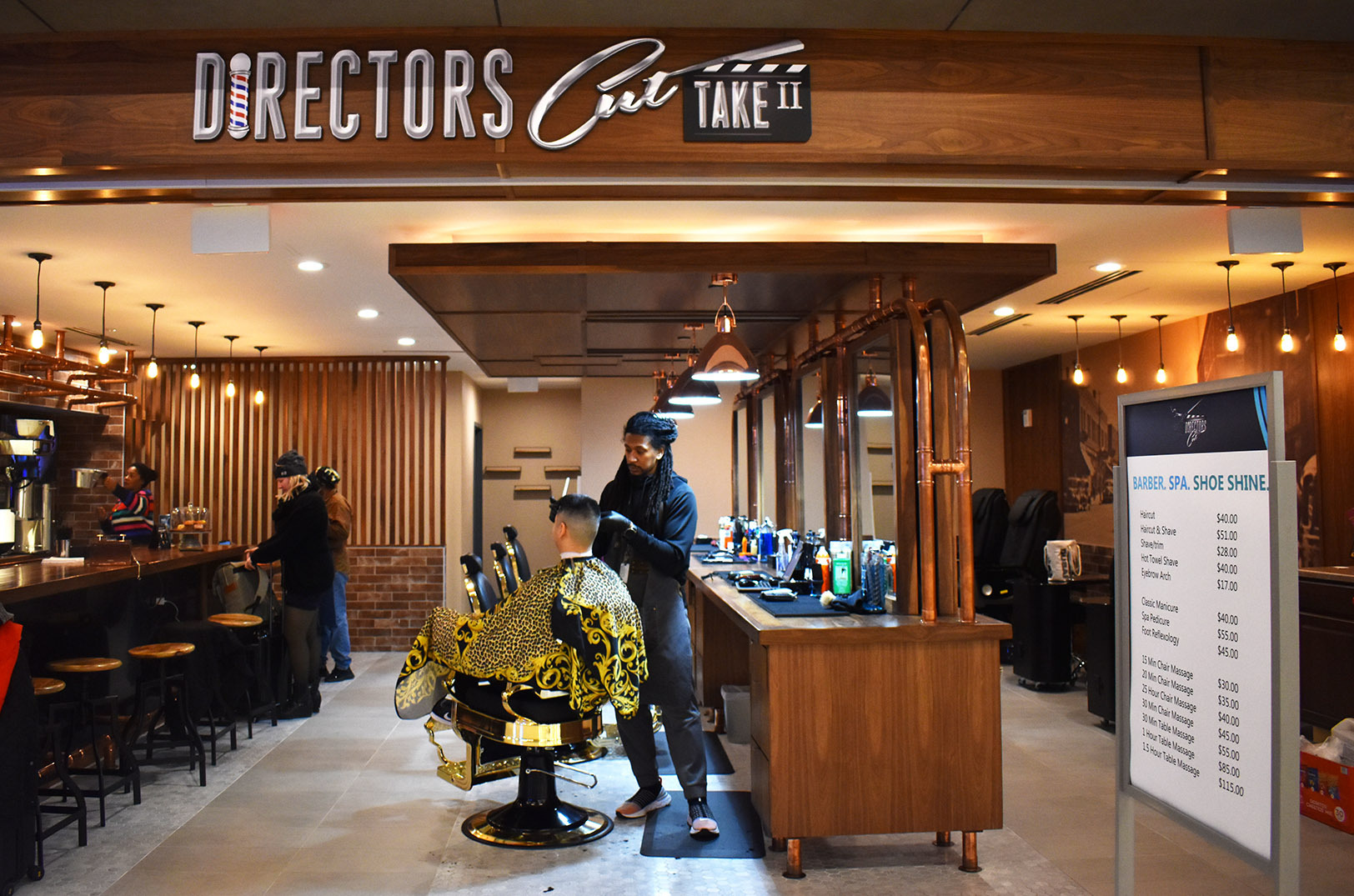 Armon Lasker cuts a patron's hair at Director’s Cut: Take Two in the Kansas City airport; photo by Taylor Wilmore, Startland News