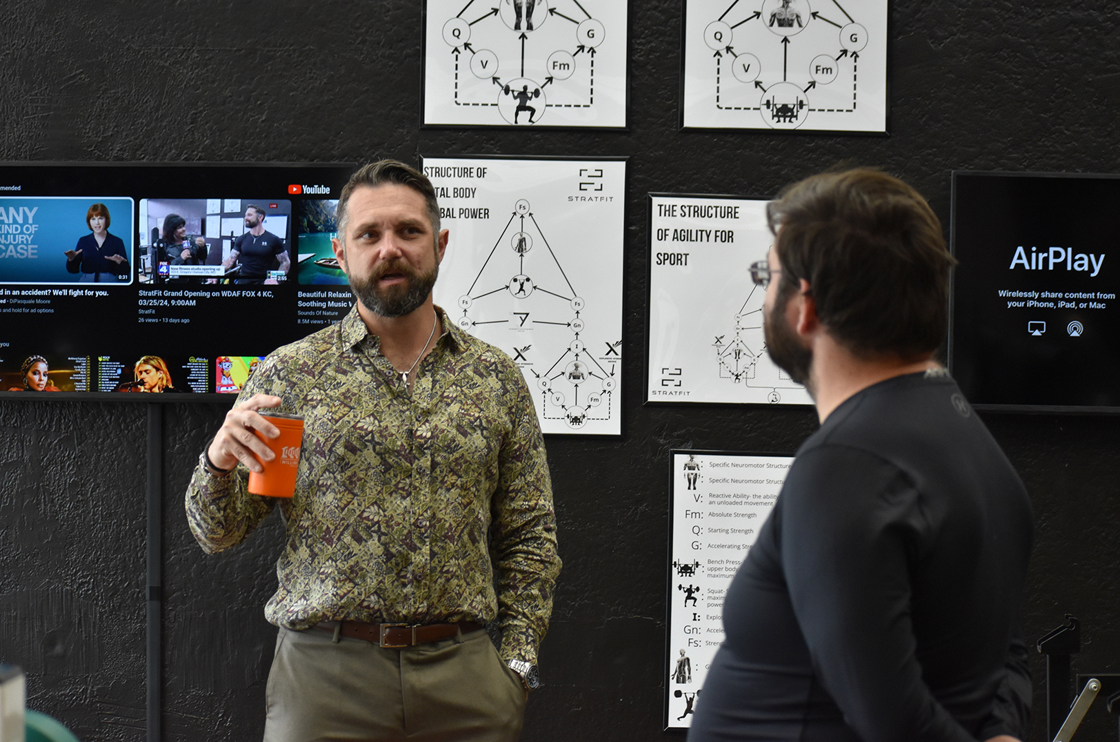 Daniel McKee, StratFit, speaks with a client at the StratFit training studio; photo by Taylor Wilmore, Startland News