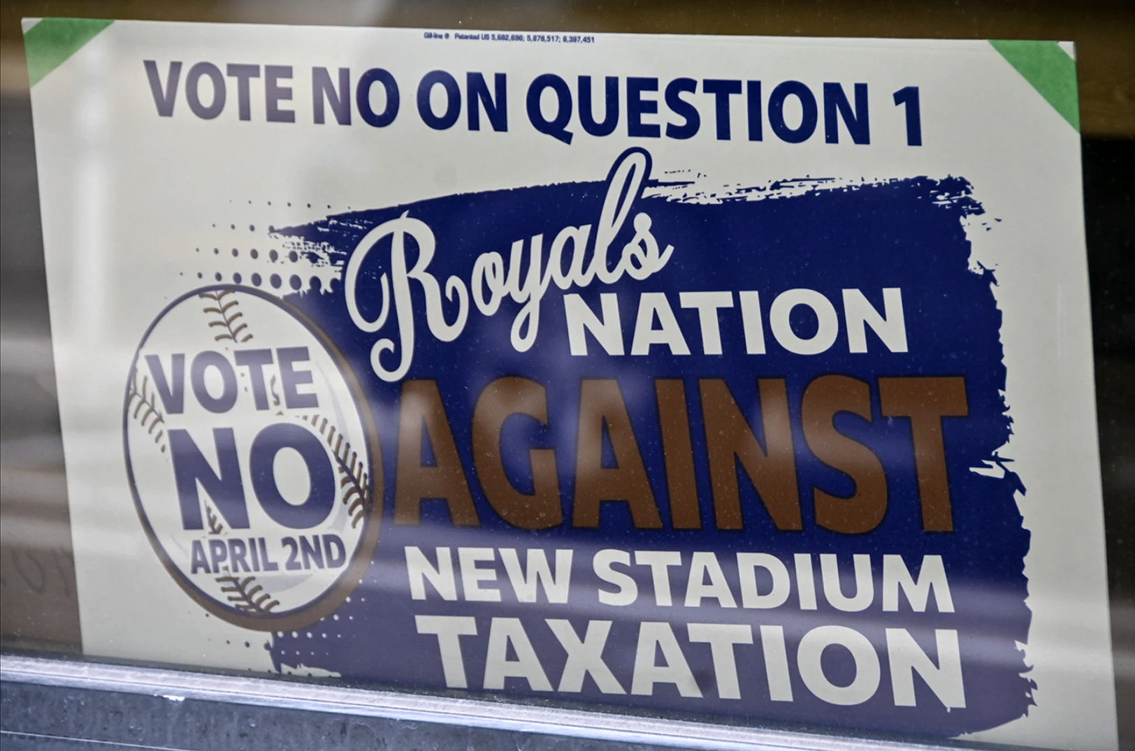 A sign in a store front near the intersection of 16th and Oak Streets on March 25, 2024 advocates against a 3/8-cent stadium tax; photo by Carlos Moreno, KCUR