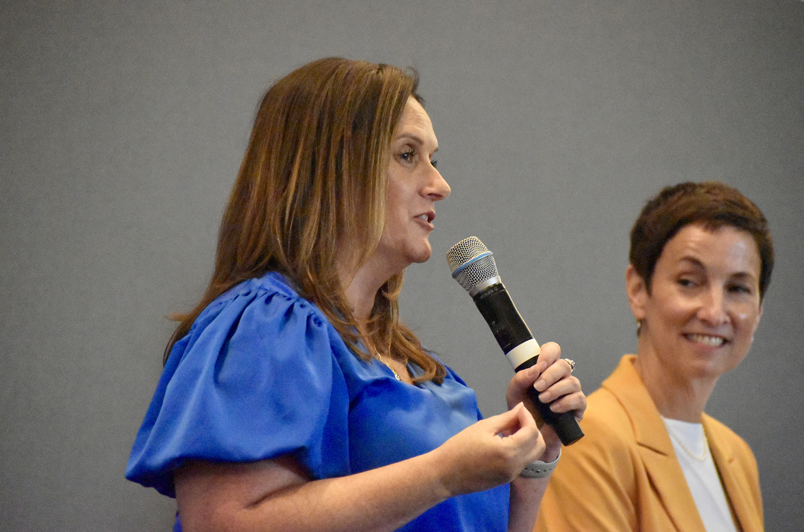 Karen Crnkovich, DMC Service, speaks from the KC Chamber's Top 10 panel conversation as Tammy Broaddus, Overflow, looks on; photo by Nikki Overfelt Chifalu, Startland News