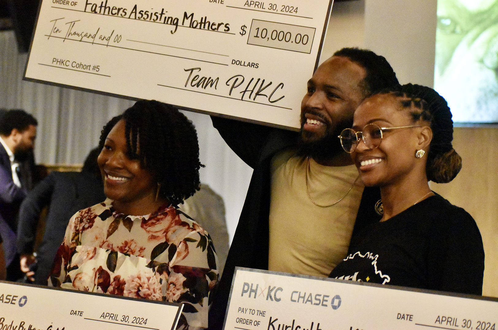 Iyshia Sims, 'Amir'acle Body Butters and More, James Hogue, Fathers Assisting Mothers, and Ravon Jefferson, Kurl Culture KC, celebrate with their checks during Porter House KC's Pitch Night event. Photo by Nikki Overfelt Chifalu, Startland News