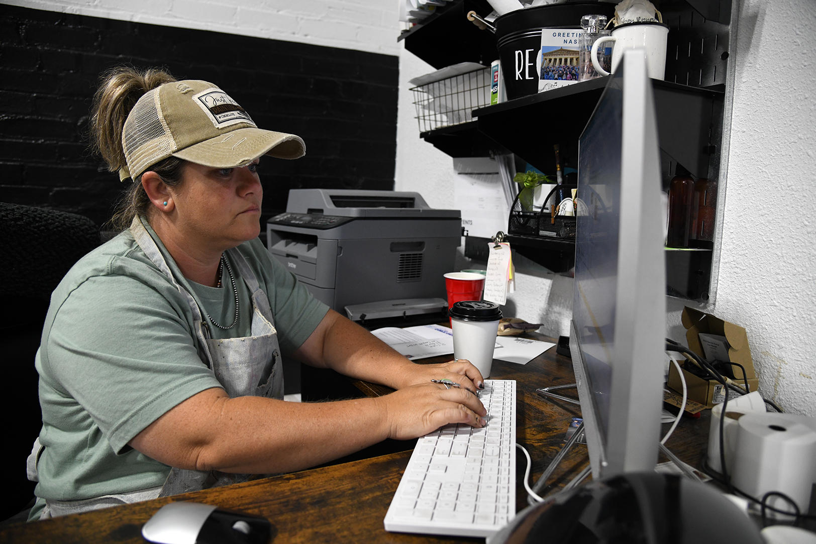 RiOak Design owner Ashley Raetz works at her desk in Cole Camp, Missouri