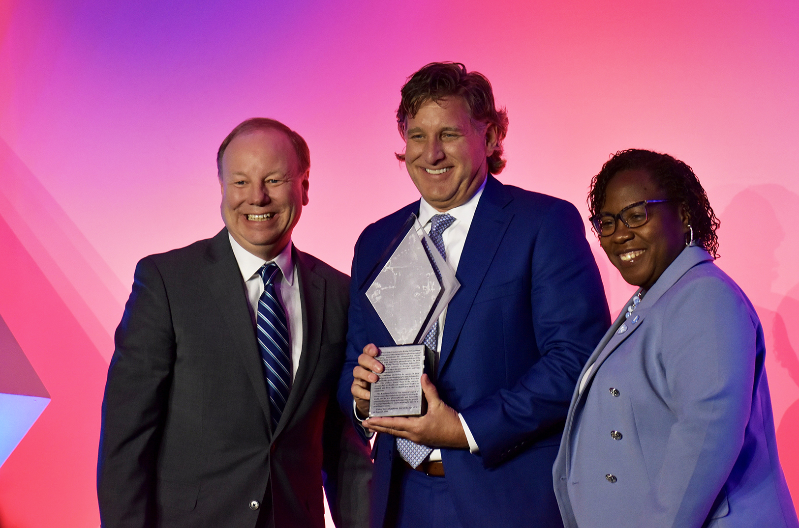 Charlie Tetrick, president and CEO of Walz Tetrick Advertising, center, accepts the 2024 Small Business of the Year honor from Joe Reardon, president and CEO of the KC Chamber, and Dr. DeAngela Burns-Wallace, president and CEO of the Ewing Marion Kauffman Foundation; photo by Nikki Overfelt Chifalu, Startland News