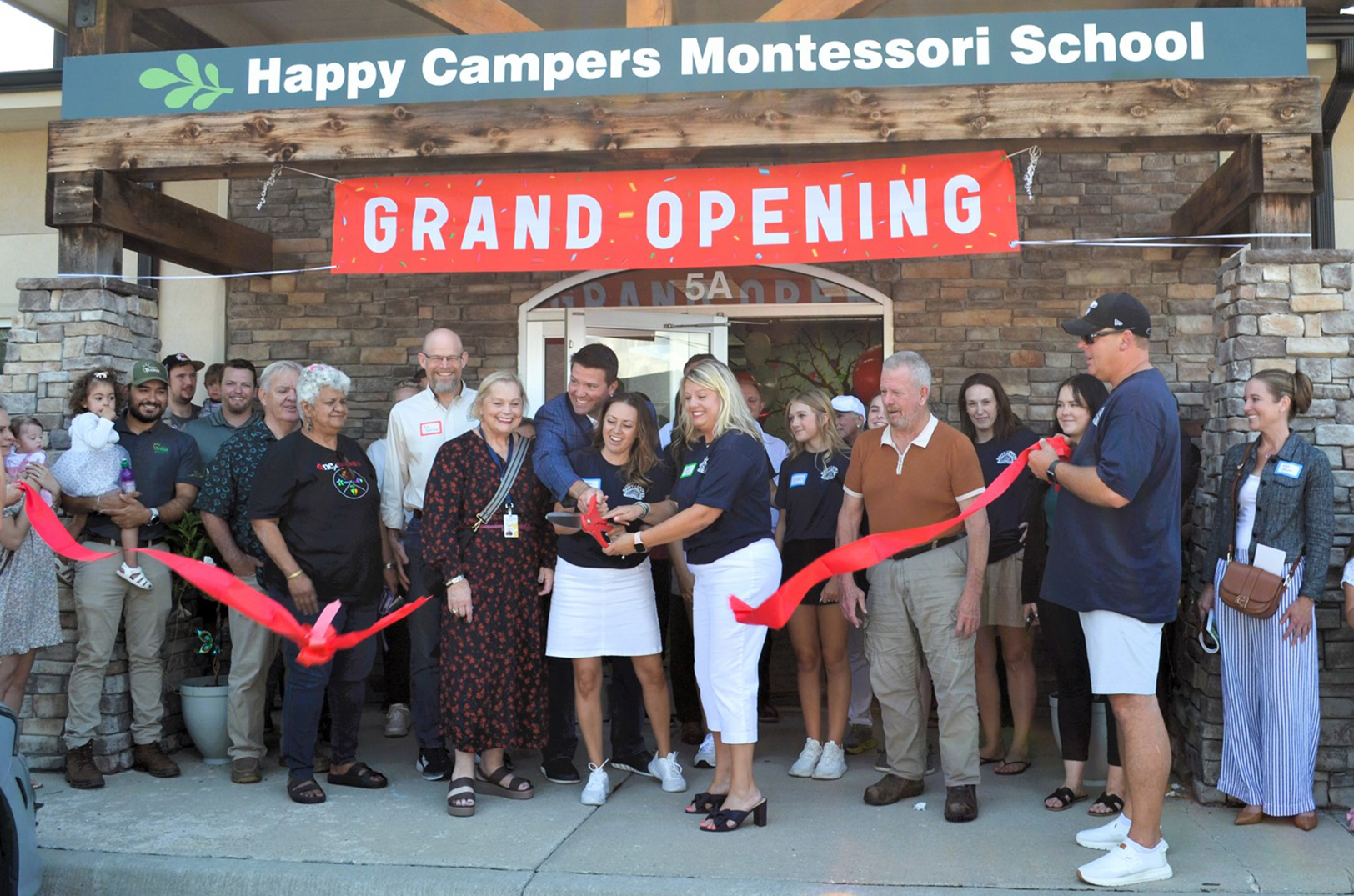 Officials cut the ribbon on Happy Campers Montessori School in west Shawnee at the business' grand opening; photo courtesy of ECJC