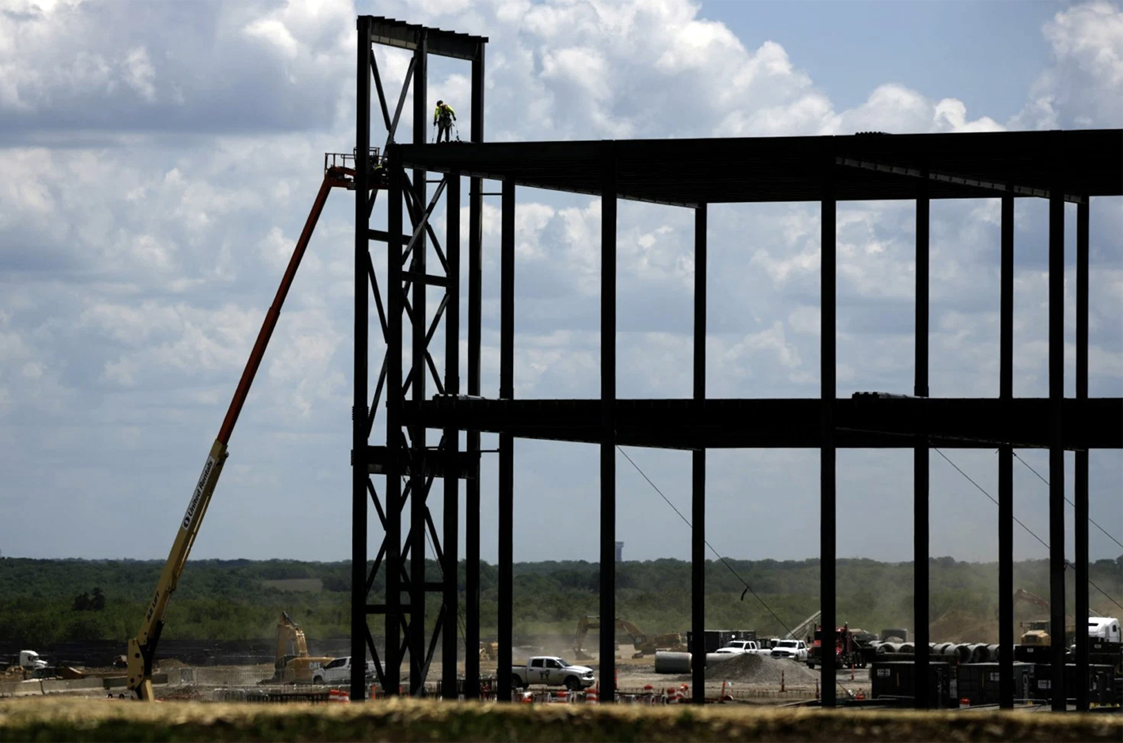 Ironworkers construct the framework of a $4 billion Panasonic EV battery plant on Thursday, May 18, 2023, near DeSoto, Kansas; photo by Charlie Riedel, Associated Press