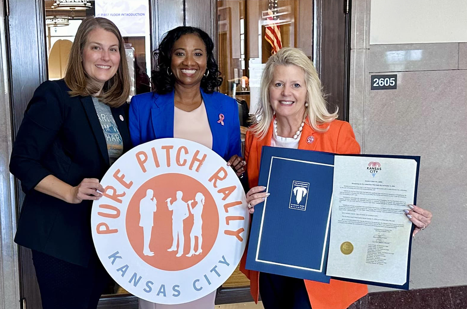 Lee Stiegemeier, co-founder of Circle Sideways; Ryana Parks-Shaw, KCMO city councilwoman; and Karen Fenaroli, founder of the Pure Pitch Rally, pose with proclamation declaring Oct. 21 Pure Pitch Rally Day in Kansas City; photo courtesy of Pure Pitch Rally