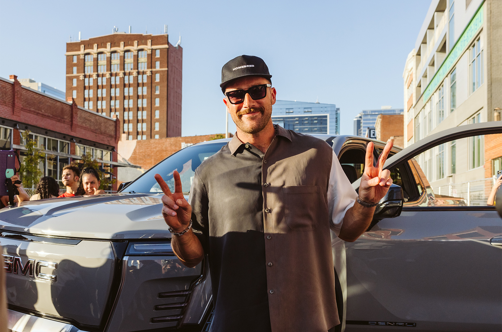 Travis Kelce, tight end for the Kansas City Chiefs and founder of the Eighty-Seven and Running Foundation, poses during the Kelce Car Jam in the Crossroads Arts District; photo by Adri Guyer, courtesy of Platinum XP