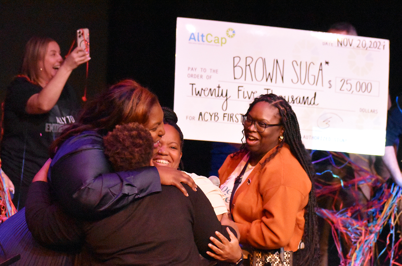 Leaders from Brown Suga embrace Shanee Kimber, event judge and an AltCap Your Biz sponsor from UMB Bank after winning the 2024 competition; photo by Taylor Wilmore, Startland News