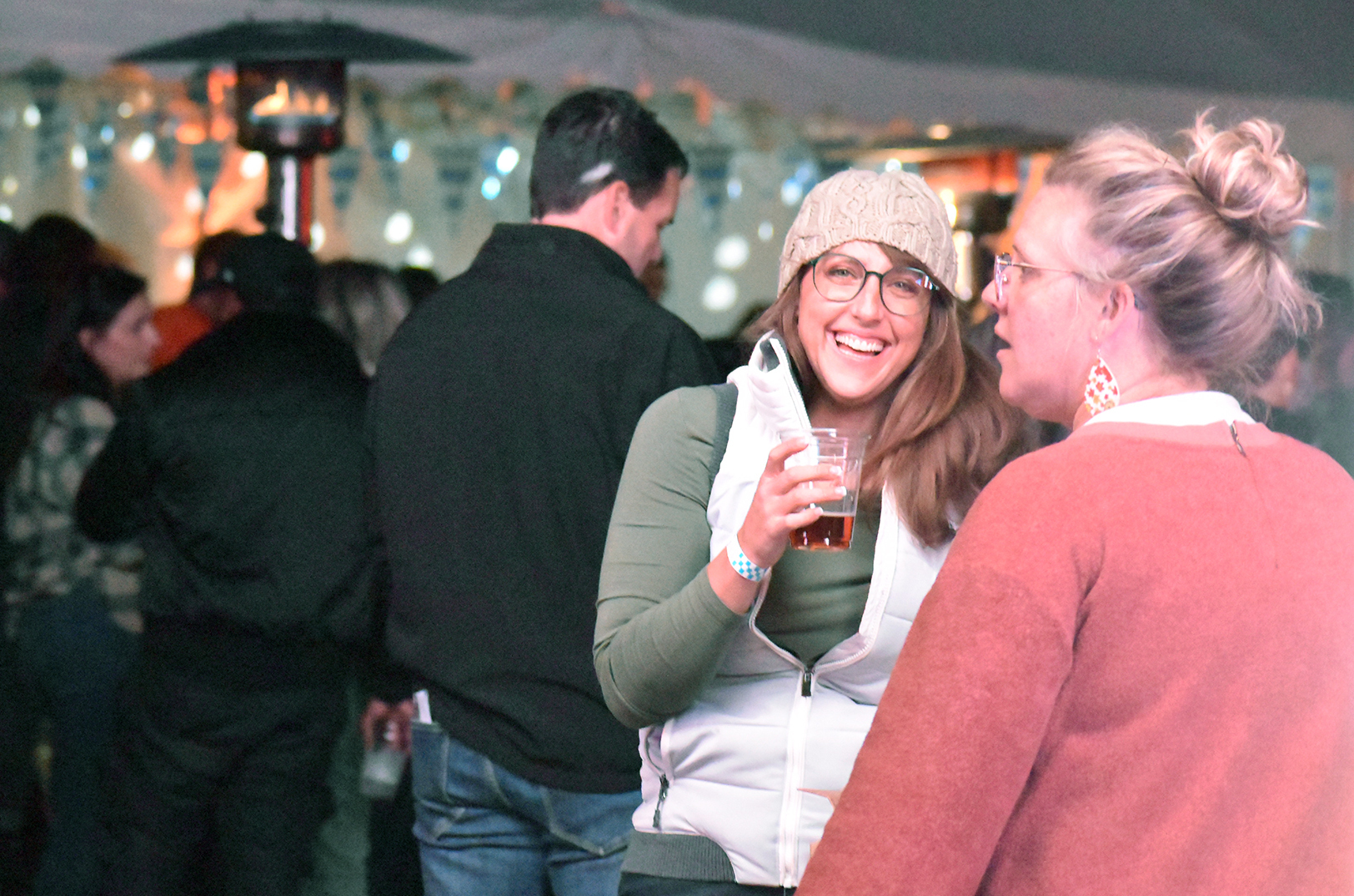 Attendees of the 2024 ARtechBBQ gather around heaters at the Kansas Speedway for drinks, barbecue and musical entertainment during the annual American Royal World Series of Barbecue; photo by Taylor Wilmore, Startland News