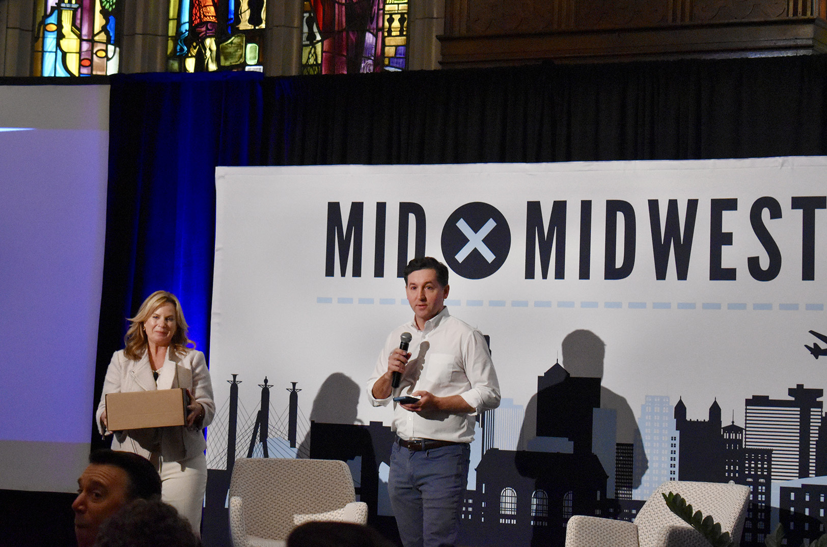 MidxMidwest organizers Maggie Kenefake, Iron Prairie Ventures, and Dan Kerr, Flyover Capital, speak during the annual conference; photo by Nikki Overfelt Chifalu, Startland News