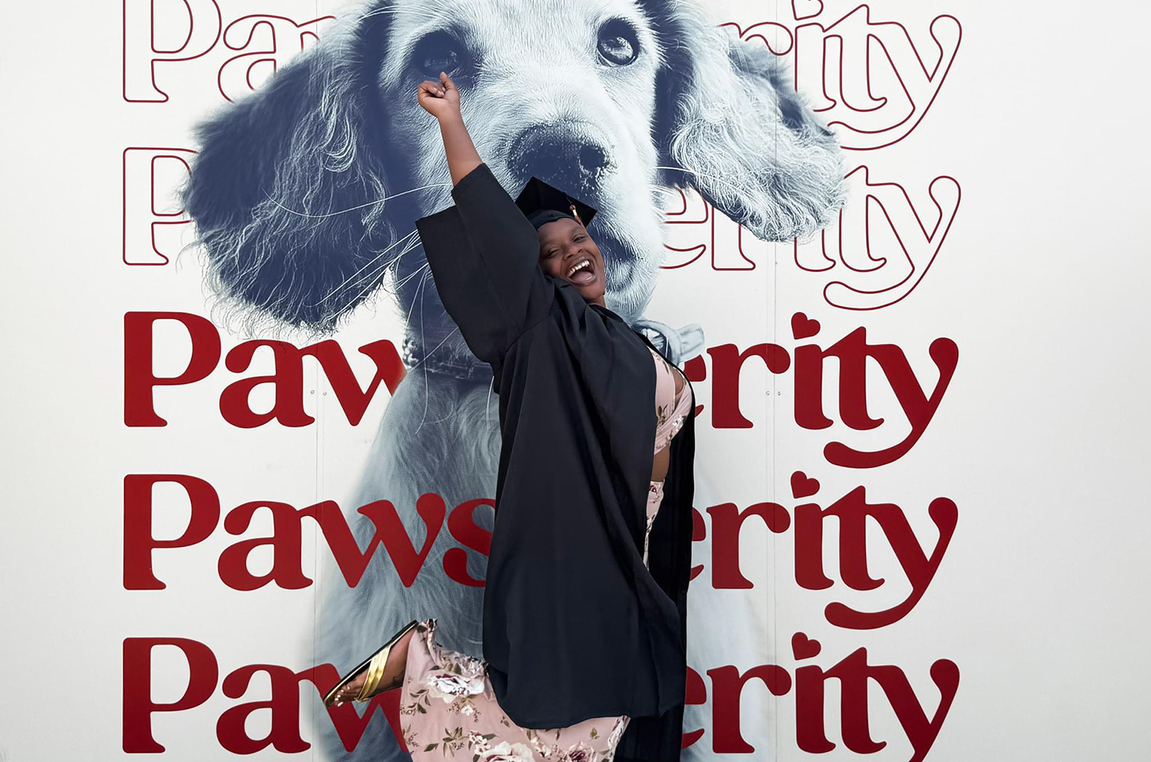 A graduate of the grooming school at Pawsperity — a nonprofit job training program — celebrates after a September ceremony; photo courtesy of Pawsperity