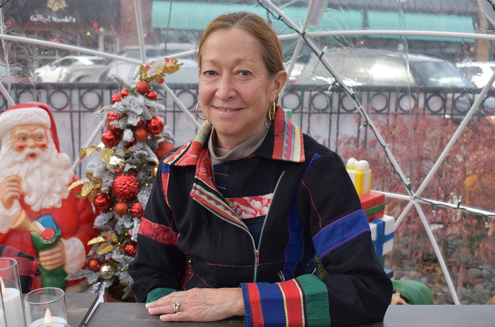 Malisa Monyakula, Lulu’s Thai Noodle Shop, sits inside an outdoor holiday igloo at her Overland Park restaurant; photo by Taylor Wilmore, Startland News