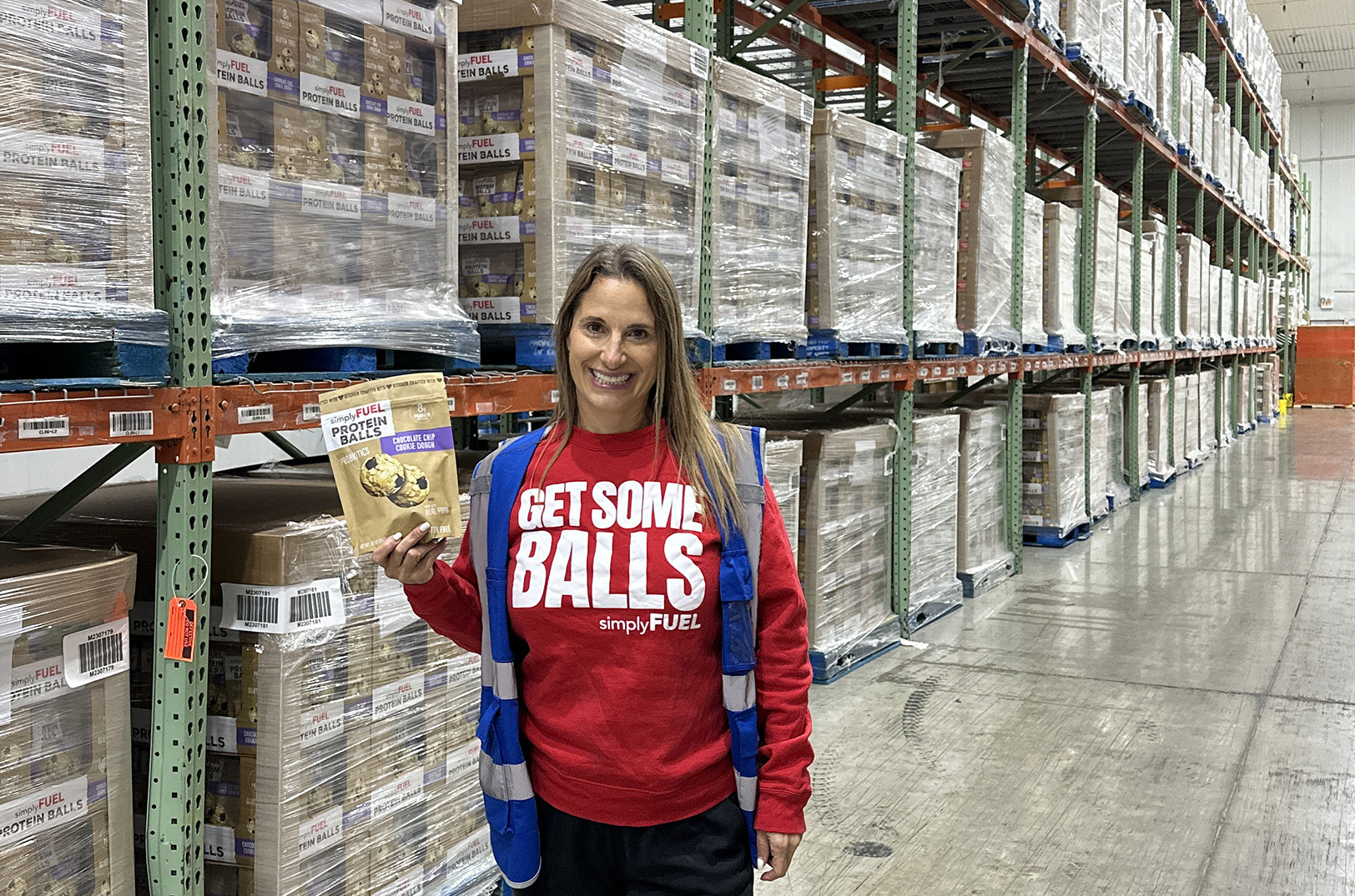 Mitzi Dulan, SimplyFUEL, stands with pallets of her protein balls; courtesy photo