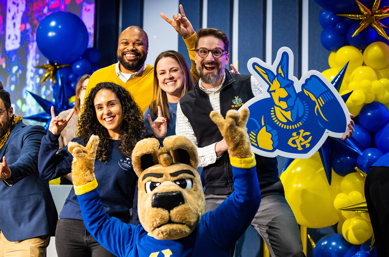 Kasey the Kangaroo, flanked by UMKC officials, celebrates the university's new Carnegie R1 research status; photo courtesy of UMKC
