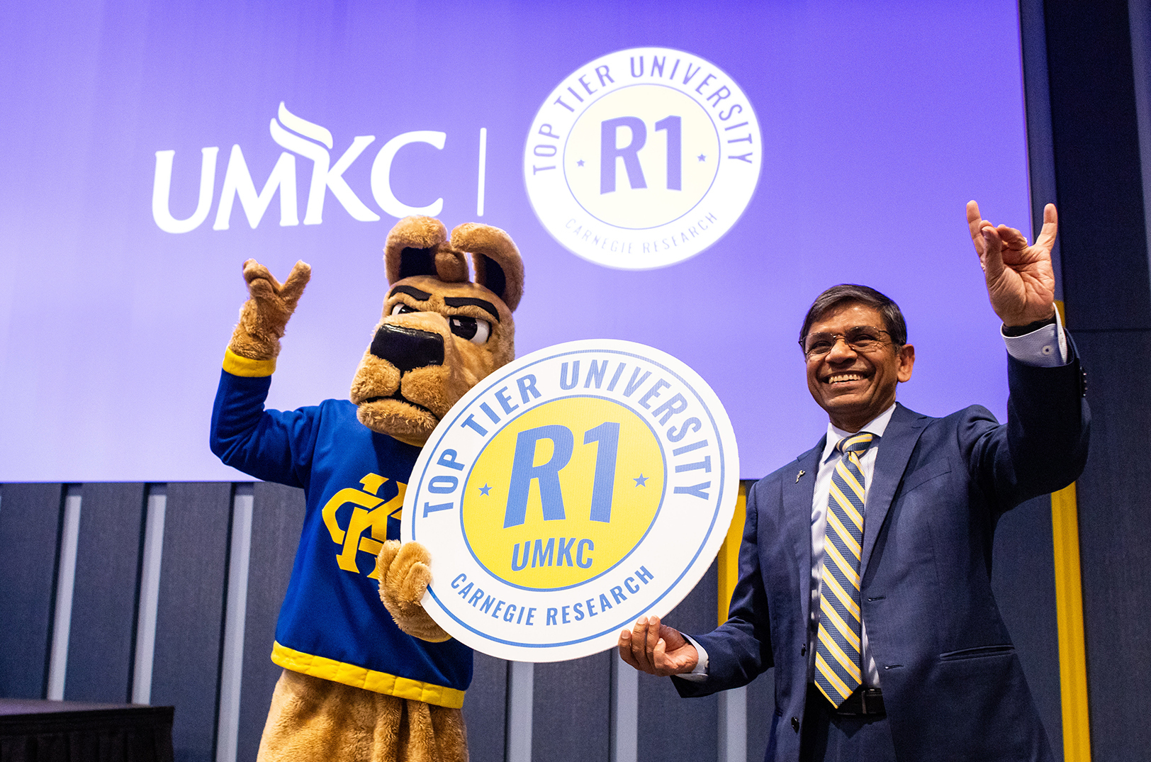 Kasey the Kangaroo joins Mauli Agrawal, chancellor of UMKC, in celebration of the university's new R1 research status; photo courtesy of UMKC