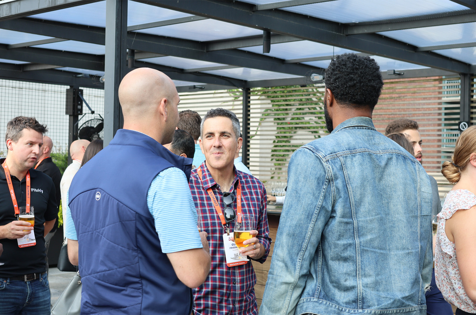 Guy Friedman, center, networks at the Club M25 Summit in Chicago in September 2024; photo courtesy of M25