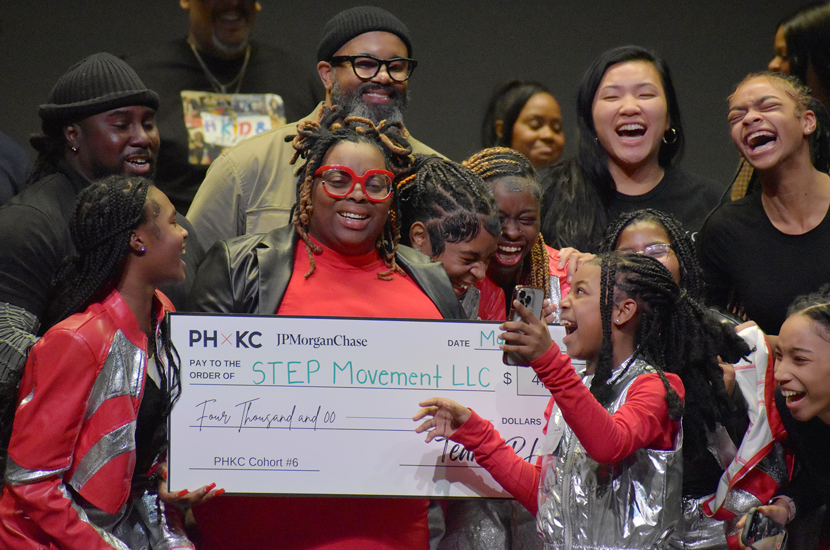 Jacquinta Nelson and members of S.T.E.P. Movement celebrate after winning the grand prize at The Porter House KC's pitch competition; photo by Taylor Wilmore, Startland News
