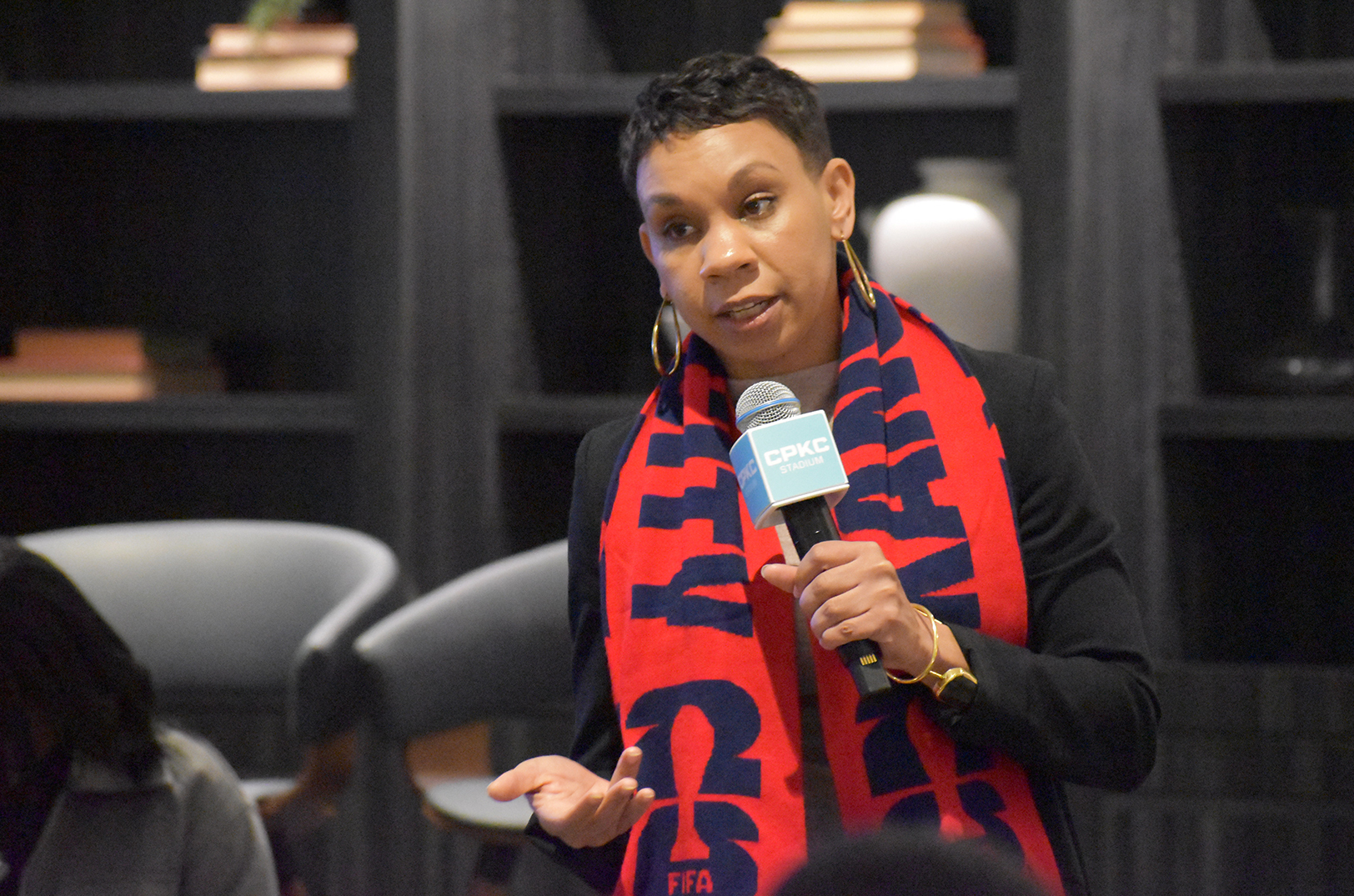 Nia (Richardson) Webster, assistant director of Neighborhood Services Department, addresses a crowd gathered at CPKC Stadium for a roundtable discussion about preparing small businesses for the 2026 World Cup in Kansas City; photo by Taylor Wilmore, Startland News