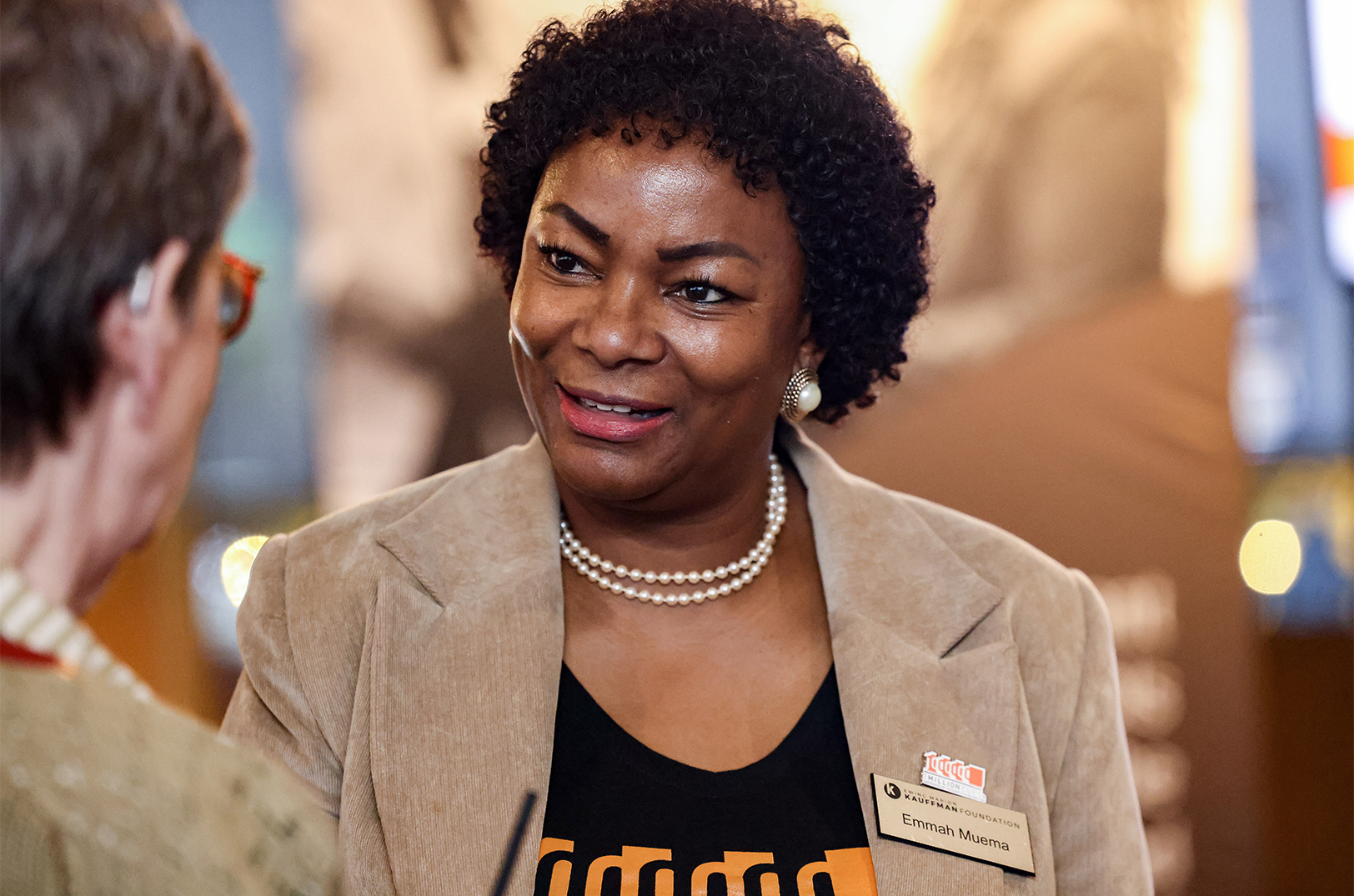 Dr. Emmah Muema, Ed.D., program manager for 1 Million Cups at the Ewing Marion Kauffman Foundation, speaks with attendees of a GEWKC happy hour event for 1 Million Cups and FastTrac; photo courtesy of the Ewing Marion Kauffman Foundation