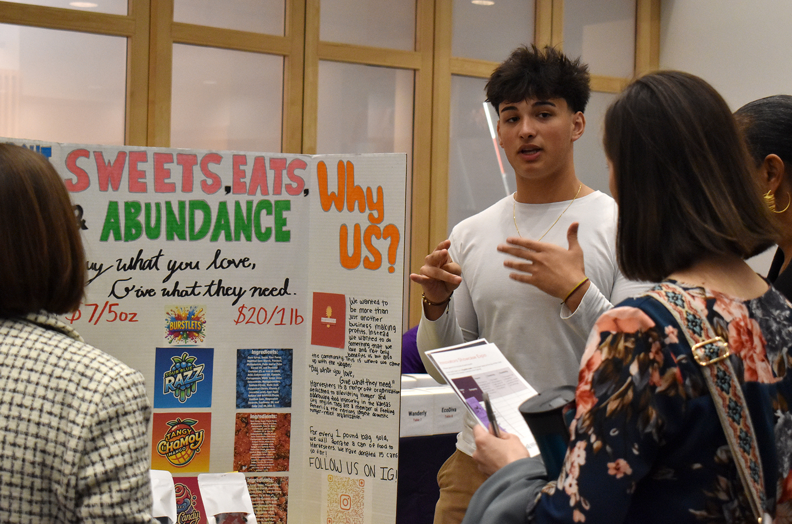 A student from the team Sweet Eats and Abundance — which earned the Operational Excellence Award — details his group's business concepts during a venture showcase through 3DE by Junior Achievement at the Ewing Marion Kauffman Foundation Center; photo by Taylor Wilmore, Startland News