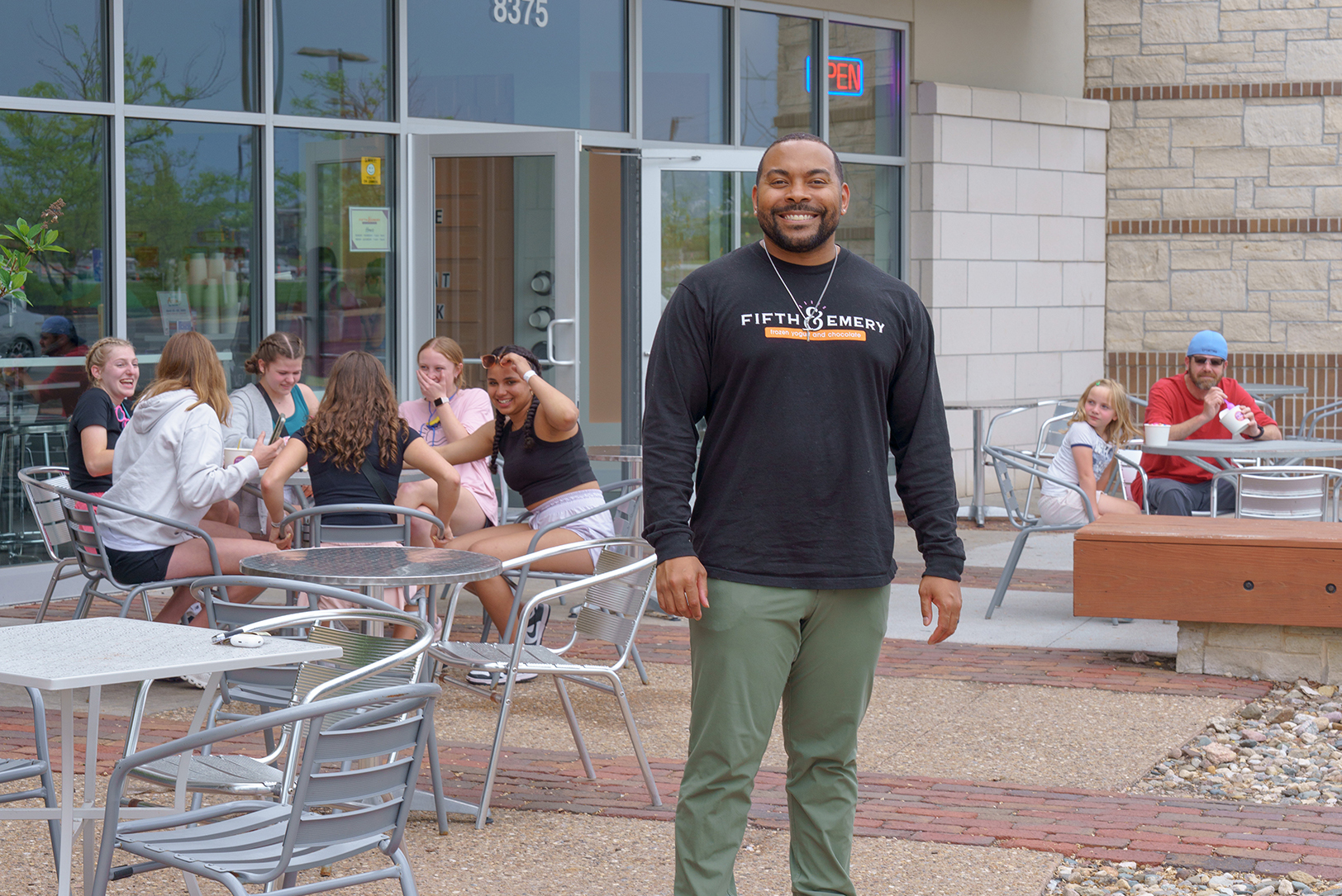 Owner Isaac Collins stands outside his Fifth & Emery Frozen Yogurt and Chocolate location at Shoal Creek; courtesy photo